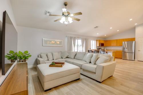 a living room with a couch and a ceiling fan at Spacious and Fenced Yard Pet-Friendly Surprise Home in Surprise