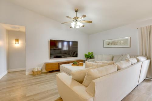 a living room with a white couch and a tv at Spacious and Fenced Yard Pet-Friendly Surprise Home in Surprise