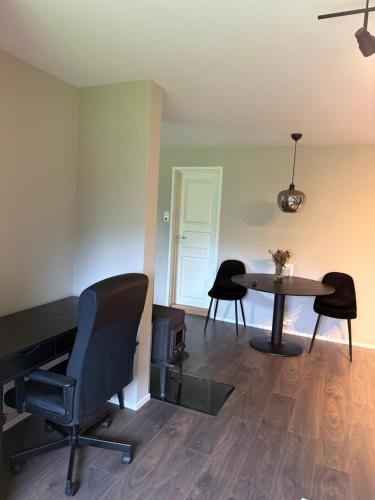 a room with a table and two chairs and a table at Hybel hauslia kristiansand in Kristiansand
