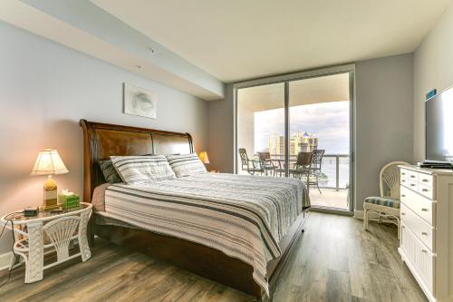 a bedroom with a bed and a balcony at Heated Pool Access! Waterfront Fort Myers Condo in Fort Myers