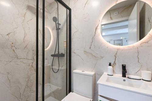 a bathroom with a toilet and a sink and a mirror at Largo da Praça Boutique by Sé Apartamentos in Braga