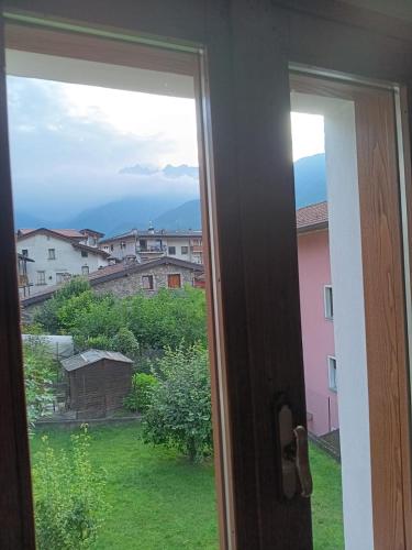a window with a view of a green field at Casa Sofia in Malonno