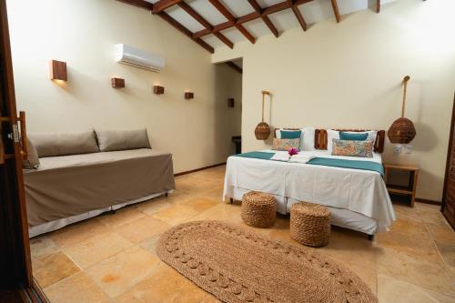 a living room with two beds and a couch at Soledade Bangalôs - Kauli Seadi in Macau