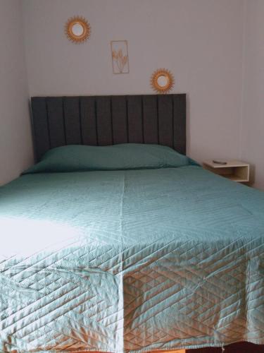a bedroom with a bed with a wooden head board at Hotel del centro rancagua in Rancagua