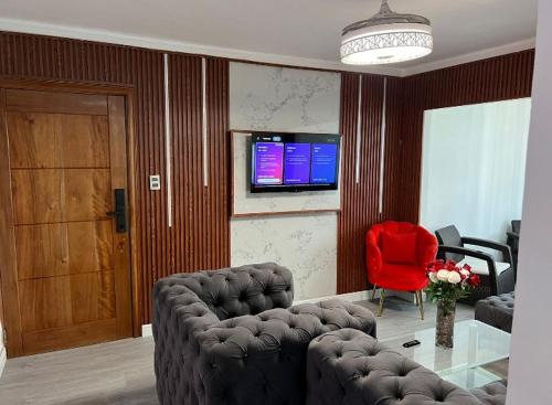 a living room with a couch and a red chair at Casaharmonia in Santo Domingo