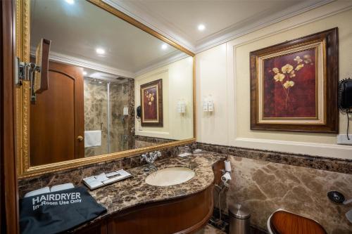 a bathroom with a sink and a mirror at Radisson Hotel Jalandhar in Jalandhar