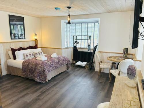a bedroom with a bed and a cart in it at St Oswalds Estate Lodges in Whitby