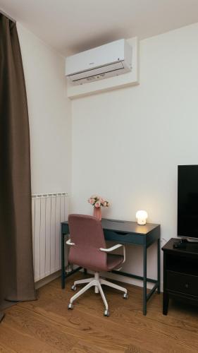 a room with a desk and a chair and a air conditioner at Belgrade Waterfront Sky Apartment in Belgrade