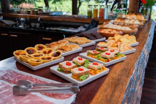 a buffet with different types of food on a table at Soledade Bangalôs - Kauli Seadi in Macau