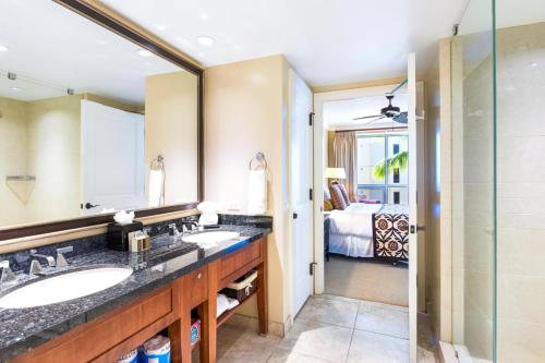 a bathroom with two sinks and a shower at Partial Ocean View 1-Bedroom Villas at Honua Kai Hokulani by KBM in Kaanapali Airport