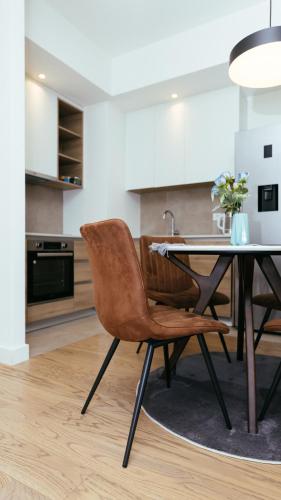 a dining room with a table and a chair at Belgrade Waterfront Sky Apartment in Belgrade