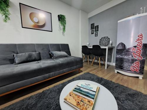 a living room with a couch and a table at Lindo Studio Largo da Carioca Metrô VLT Lapa in Rio de Janeiro