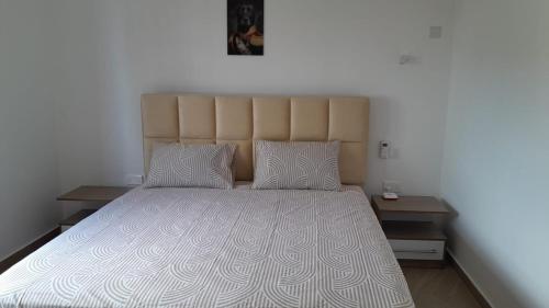 a bedroom with a large bed with a large headboard at West Coast Dream in Mauritius