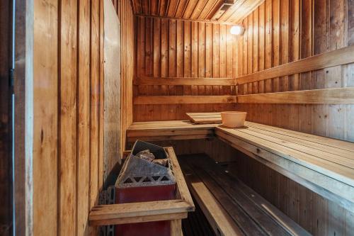 an inside of a wooden sauna with a box in it at Quiet Asoke/Nana BTS Retreat w/ Skyline & Gym/Park in Bang Kapi