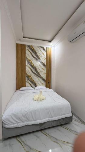 a bedroom with a bed with two bananas on it at Homely Guest House in Samarinda
