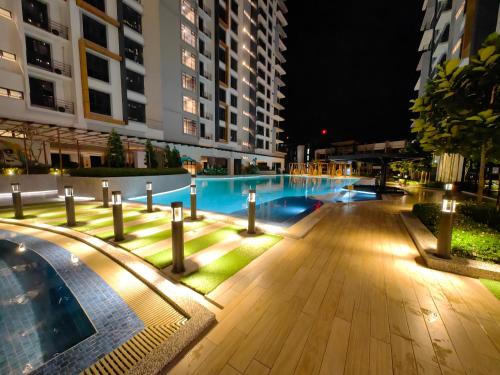 a swimming pool at night with lights at K Avenue Modern Style Studio (5 Mins to Airport) in Kota Kinabalu