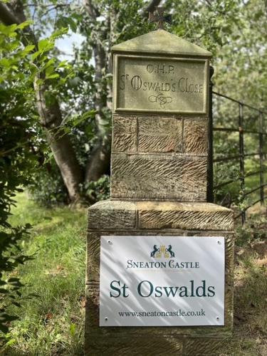 a sign for the st oswald chase station castle at St Oswalds Estate Lodges in Whitby