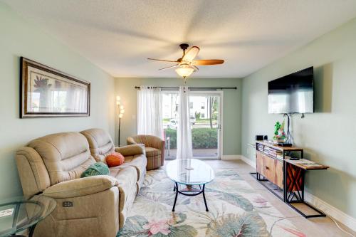 a living room with a couch and a table at Walk to Beach 1st-Floor Unit with Pool in Melbourne in Indian Harbour Beach