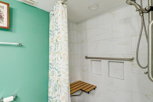 a bathroom with a shower with a shower curtain at Walk to Beach 1st-Floor Unit with Pool in Melbourne in Indian Harbour Beach