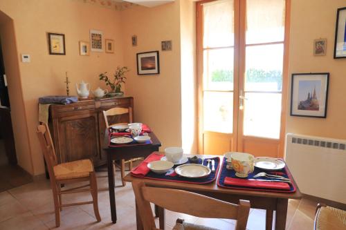 a dining room with a table and chairs and a window at Bair Nestad in Assigny