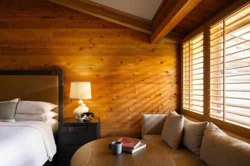 a bedroom with a bed and a wooden wall at Alila Ventana Big Sur - Inclusive Resort in Big Sur
