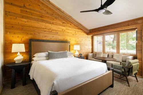 a bedroom with a large white bed and wooden walls at Alila Ventana Big Sur - Inclusive Resort in Big Sur