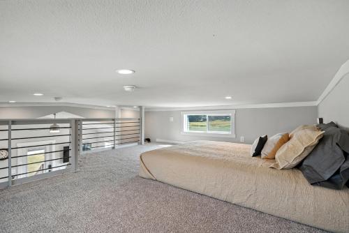 a bedroom with a large bed and a window at Dakota Sky- BRAND NEW 1 BD CABIN in Custer