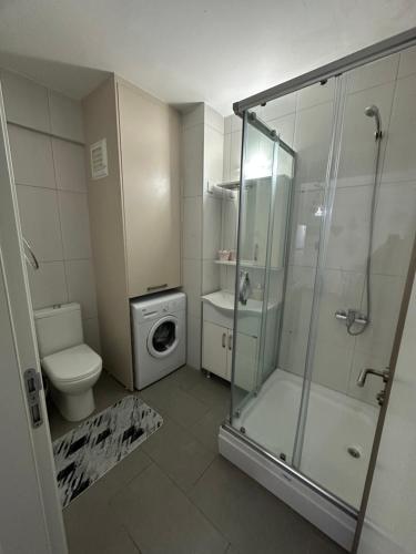 a bathroom with a shower and a toilet and a sink at North Residence Deniz Manzaralı Daire in Kérynia