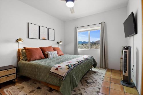 a bedroom with a bed and a flat screen tv at New Home, Big Views, Hot Tub, Gazebo! - Casa del Sol in Ranchos de Taos