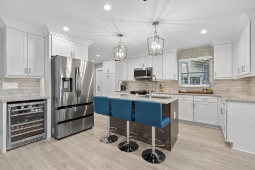 a kitchen with white cabinets and blue bar stools at Sugarfish in Sanibel Island