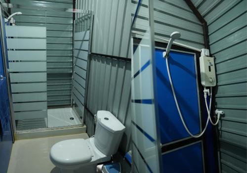 a bathroom with a toilet and a shower at A4 Hostel Colombo Airport - travellers cottage in Katunayake