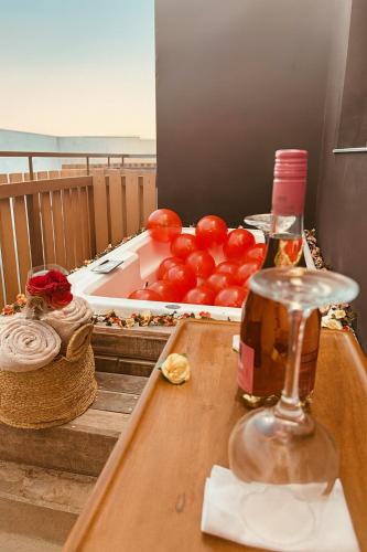 a table with a tray of tomatoes and a bottle of wine at Jungle Guardian - Rooftop Pool & Beach Club in Zona Hotelera Tulum in Tulum