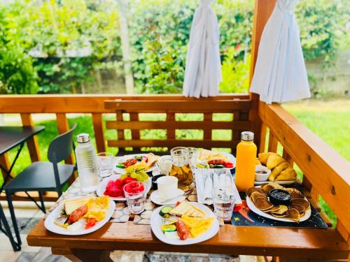 a table with plates of food and drinks on it at SARVI Apartments in Durrës