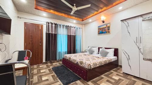 a bedroom with a bed and a ceiling fan at The Couples Paradise Balcony in Kasauli