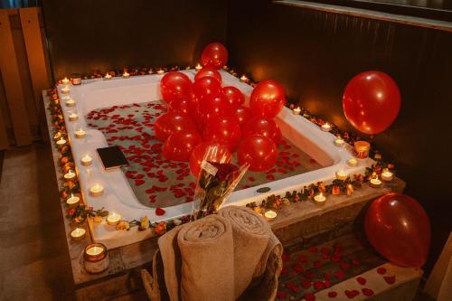 a cake with balloons in a bath tub with lights at Jungle Guardian - Rooftop Pool & Beach Club in Zona Hotelera Tulum in Tulum