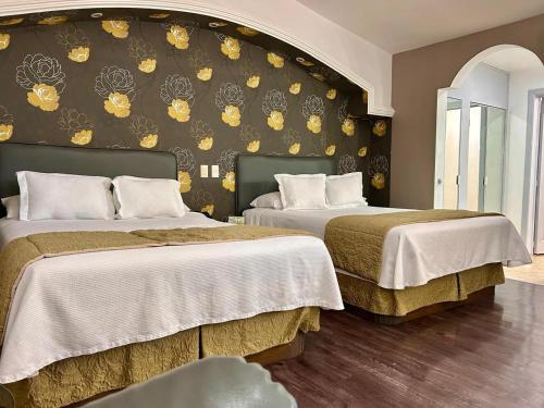 Postel nebo postele na pokoji v ubytování Hotel Baruk Teleférico Centro Histórico