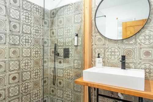 a bathroom with a sink and a mirror at Maramures Retreat & SPA in Poienile Izei