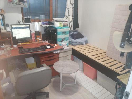 an office with a desk with a computer and a bed at Ocean House- Cheonan St in Cheonan