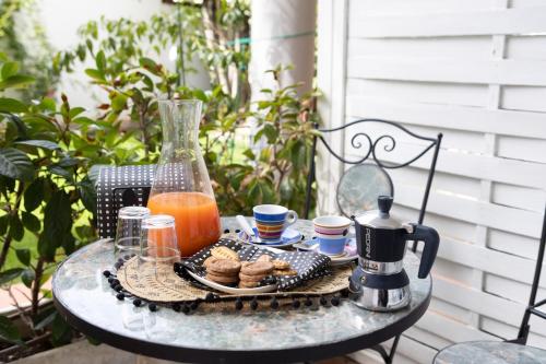 a table with a tray of food and a pitcher of juice at Villa Mirella - Luxury in the center of Tuscany in Empoli