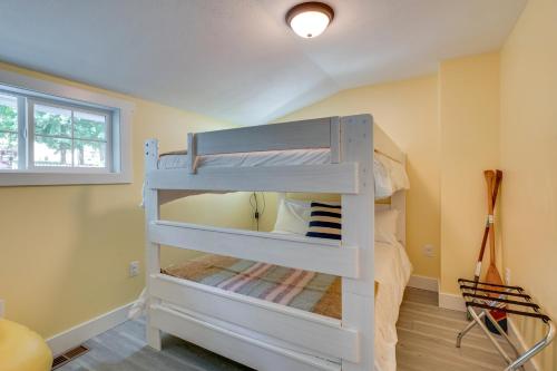 a bunk bed in a room with yellow walls at Waterfront Deck with Fire Pit Lake Spokane Gem! in Deer Park