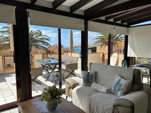 a living room with a couch on a patio at Ferienhaus Vista Mar in Costa Calma