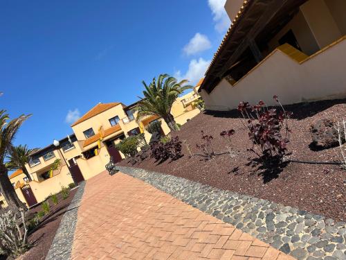 a brick walkway in front of a house with plants at Ferienhaus Vista Mar in Costa Calma