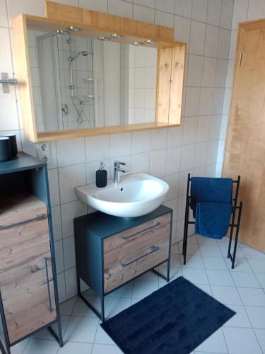 a bathroom with a sink and a mirror at 2-3 Personen Apartment mit Bergblick in Landeck