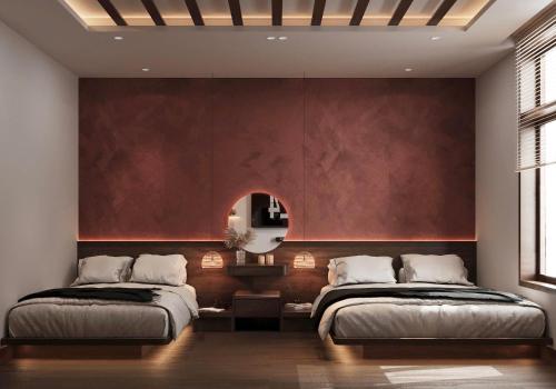 two beds in a bedroom with a red wall at Nana Homestay & Villa in Hue