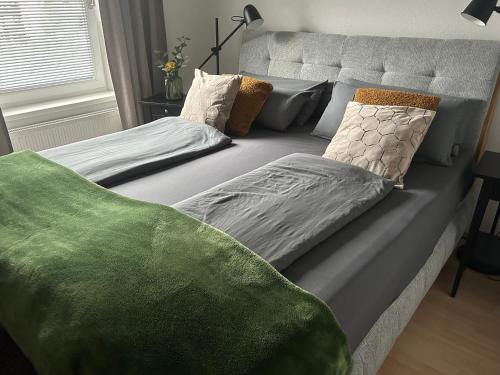 a bed with pillows on it in a bedroom at 2-3 Personen Apartment mit Bergblick in Landeck