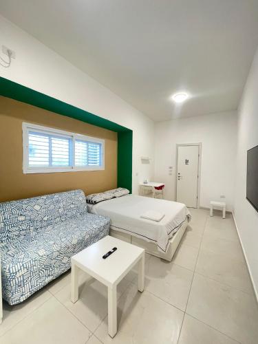 a living room with a bed and a couch at Zan in Netanya