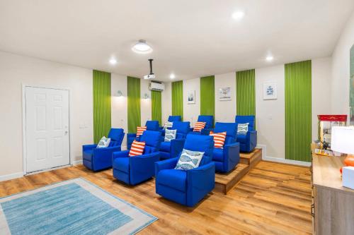 a room with blue chairs and green and white walls at Resort Style Backyard Pool Pickleball Court in Lake Dallas