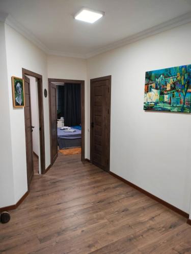 a hallway of a room with a painting on the wall at A unique artist's apartment in Vagharshapat