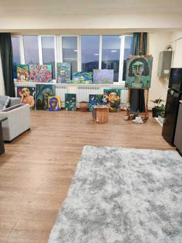 a living room filled with paintings and a couch at A unique artist's apartment in Vagharshapat