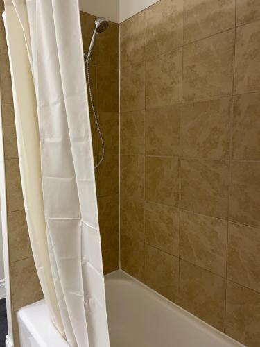a bathroom with a shower with a shower curtain at Home beside WEM in Edmonton